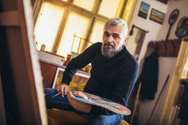 istock Mature man painting on canvas in art studio. 1225162856