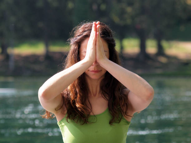 istock Woman Practicing Yoga on Pier Overlooking Lake Bled 1225163098