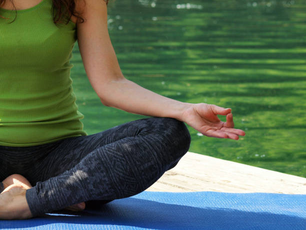 istock Woman Practicing Yoga on Pier Overlooking Lake Bled 1225163102