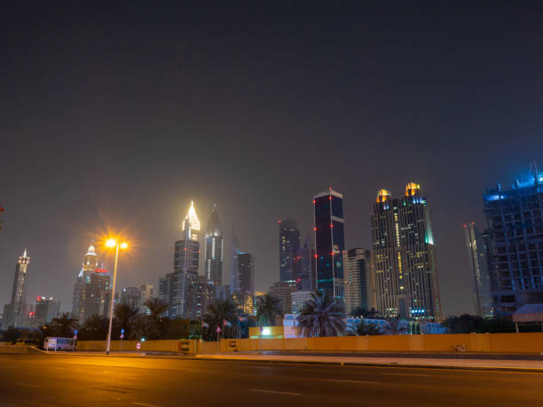 istock Dubai skyscrapers at night with road at night 1225163556