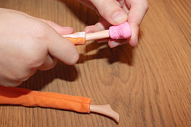 istock children's hands put shoes on a doll 1225164519