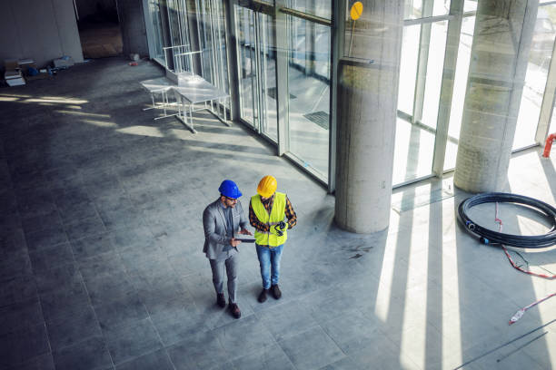 top view of contractor and architect walking around building in construction process and talking about how they gonna build it. - corporate business manager manual worker architect imagens e fotografias de stock