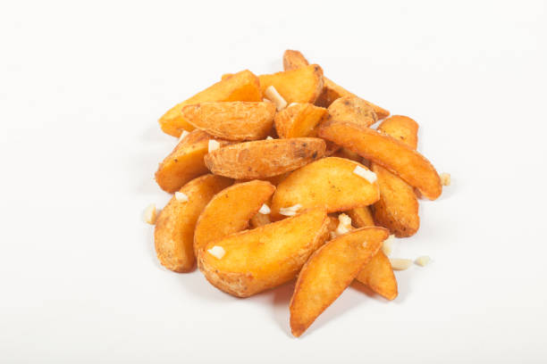 istock Rustic fried potatoes with salt, sliced garlic, on an isolated white background 1225171055