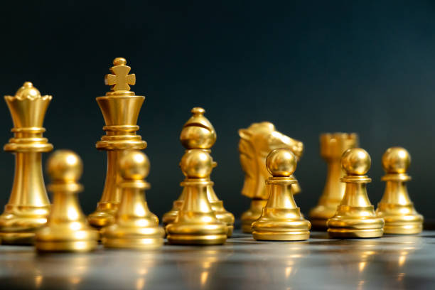 istock Gold color chess piece wait for movement on black background 1225171340