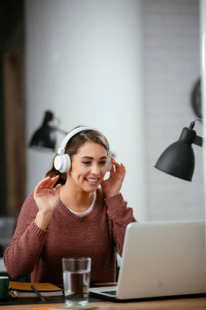 istock Beautiful woman listening the music while working. 1225173355