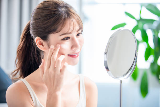 istock woman apply moisturizer on face 1225177666
