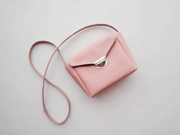 Pink pastel women handbag on a white background. Fashionable women's accessory for spring and summer.