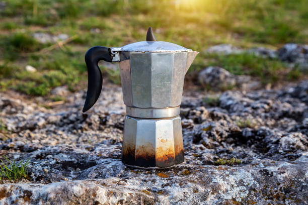 istock Metal coffee maker in nature. Making coffee. Camping in summer. 1225183378