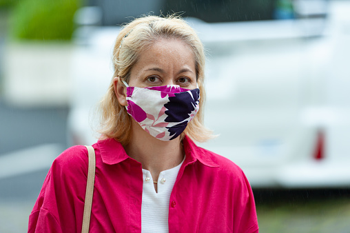 Pandemic COVID19 - Portrait of mixed race woman wearing a DIY homemade fabric face mask for protection against Coronavirus (SARS-CoV-2) and other infectious diseases.