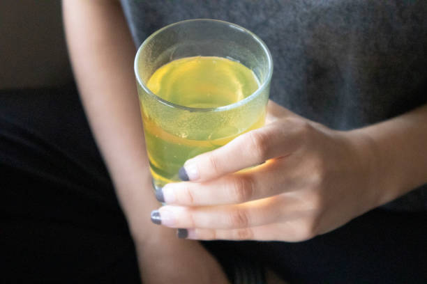 istock A woman drinking vitamins to protect herself from viruses 1225189627