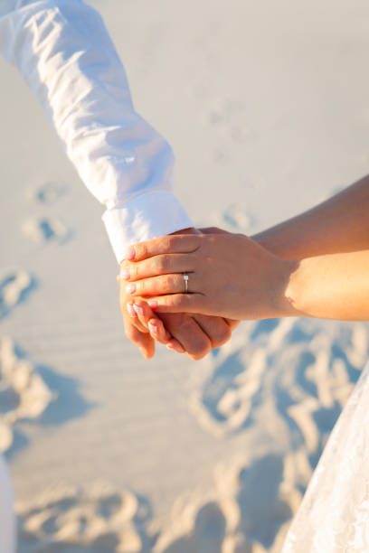 istock Lovers hold hands and walk in the white desert 1225189783