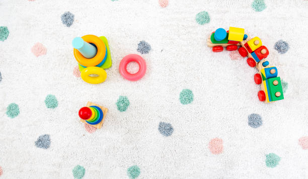 top view on colorful baby toys on a carpet background toys in the floor with copy space for text - photography carpet floor high angle view imagens e fotografias de stock