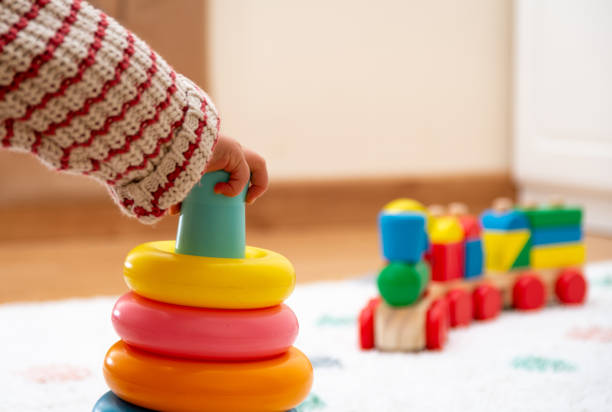 Close-up of a Baby´s Hand, Playing with a Colorful Toy. Unfocused Background stock photo