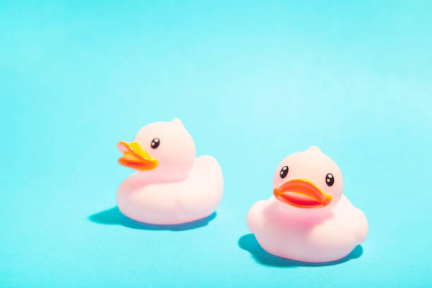 istock Pink rubber ducks organized on blue background. 1225192058
