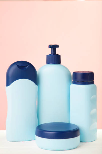 istock Blue cosmetic bottles on pink background. Top view 1225192592
