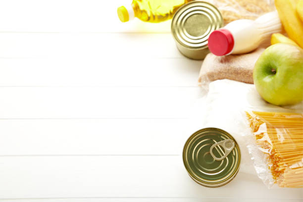 istock Food donations on the white background. Top view 1225192771