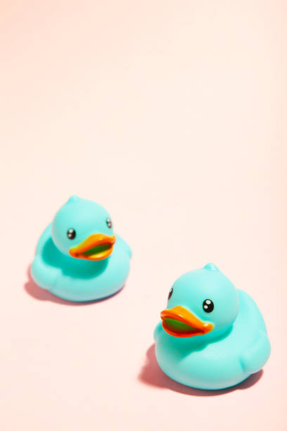 istock Blue rubber ducks organized on pink background. 1225193396