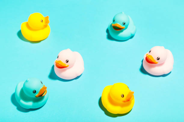 istock Collection of colorful rubber ducks on a blue background 1225193402