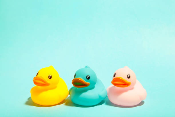 istock Colorful rubber bath ducks on blue background 1225193512
