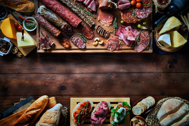 istock Tapas of cured ham and cheese delicious appetizer on rustic wood table with copy space 1225194058