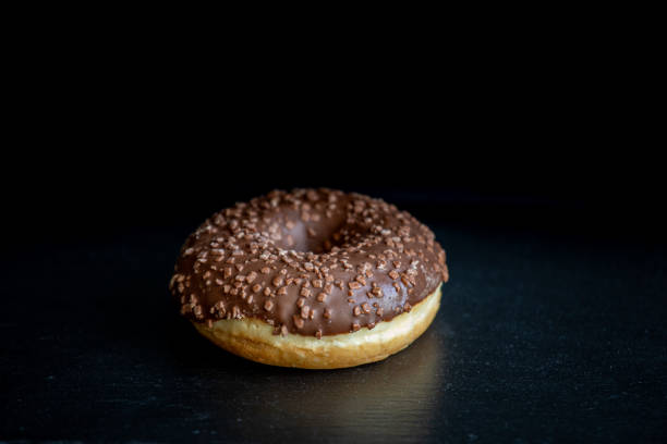 istock Sweet donut on black background. 1225194695