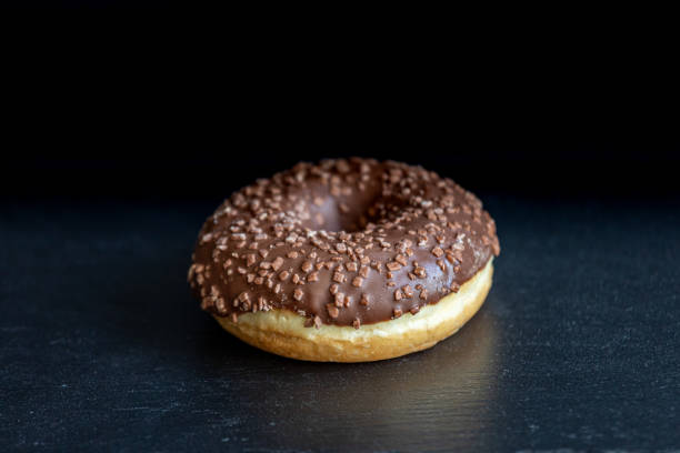 istock Sweet donut on black background. 1225194762