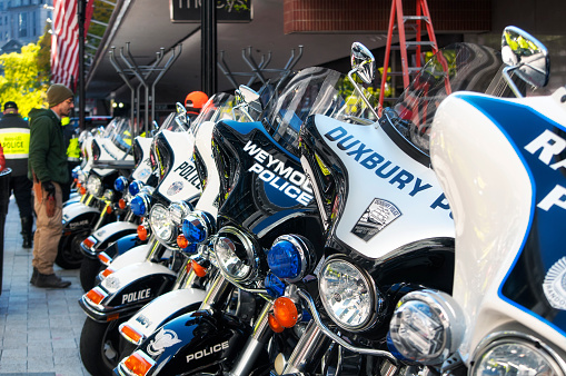 Boston, Massachusetts.  October 31, 2018. Many greater Boston Massachusetts police motorcycles lined up on a sidewalk to celebrate the Red Sox world series parade.