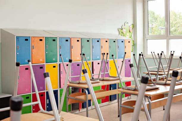 istock Classroom with colorful lockers and raised chairs on the tables 1225196529
