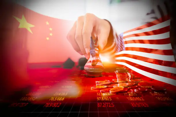 Closeup hand playing chess board with China and USA flag on stock index background, USA and China trade war concept