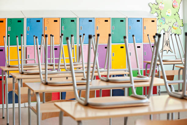 Classroom with colorful lockers and raised chairs on the tables Modern empty classroom with colorful lockers and raised chairs on the tables - back to school empty desk in classroom stock pictures, royalty-free photos & images