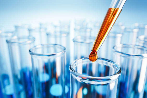 Closeup of test tubes with orange or blue liquid. Dropping glass with an orange drop above. Testing laboratory, SARS-CoV-2 test, chemical testing facility, medical testing. Selective focus on foreground. primer plano de los tubos de ensayo con líquido naranja o azul. dejar caer el vidrio con una gota de naranja por encima. laboratorio de pruebas, prueba sars-cov-2, centro de pruebas químicas, pruebas médicas. enfoque selectivo en primer plano.