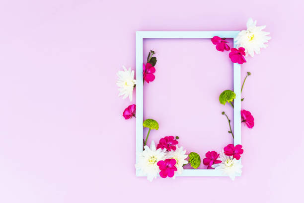 istock Flower arrangement with a white frame on a pink background. 1225199699
