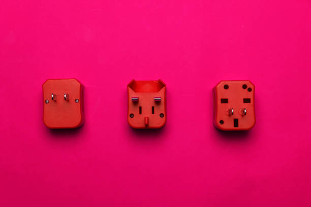vibrant three red electric multi plug socket for travel on pink background