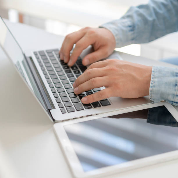istock Man typing on laptop, close up 1225203520
