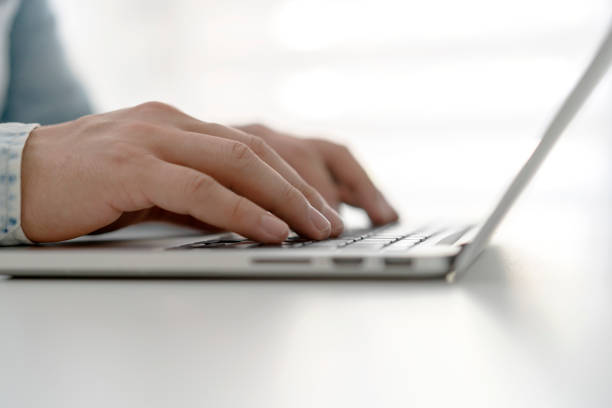istock Man typing on laptop, close up 1225203530