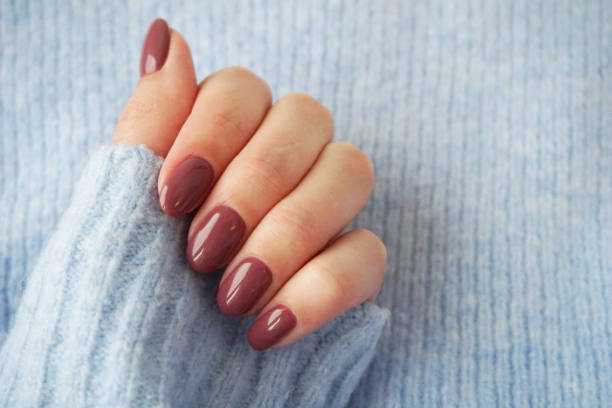 istock Violet manicure and blue sweater. 1225204696