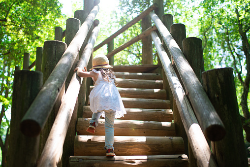 Little girl climbing the stairs in the park