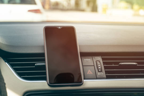 istock black screen smartphone in the vehicle center console, 1225205981