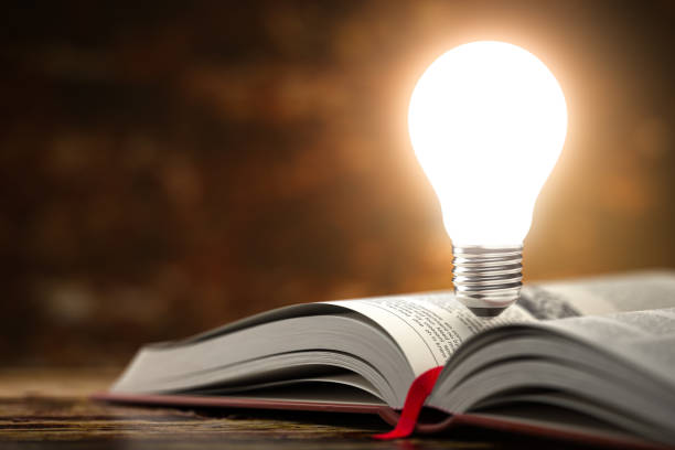 istock Light bulb on the  open book. Idea and creativity concept background. 3 1225207272