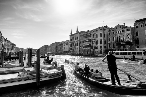 Venice, Italy - May 19, 2018. Tourists take gondola tour in Venice, Italy