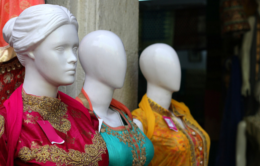 Indian woman fashion wear kurtis on mannequins in display of retail store