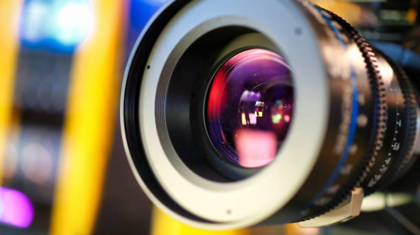 camera lens during media production event close up on media production video cameras in a recording studio, all logos or trademark signs and elements were cloned away or blurred out. 4k resolution stock pictures, royalty-free photos & images