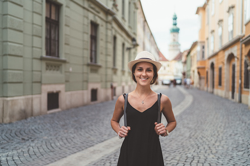 Smiling woman on travel sightseeing during the summer vacations