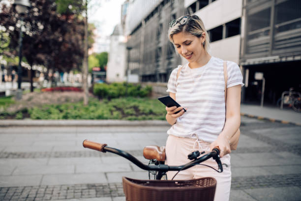 istock Beautiful young smiling woman sending a text message 1225216476