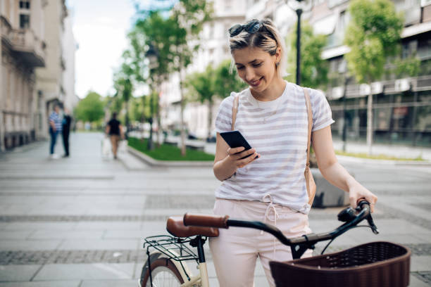 istock Beautiful young smiling woman sending a text message 1225216479