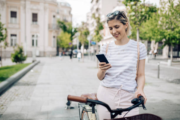 istock Beautiful young smiling woman sending a text message 1225216483