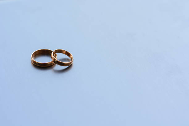 istock two traditional wedding gold engagement rings lie 1225216653