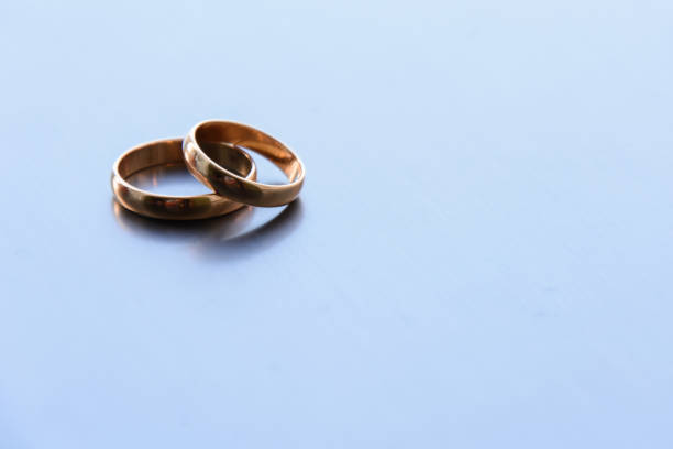 istock two traditional wedding gold engagement rings lie 1225216654