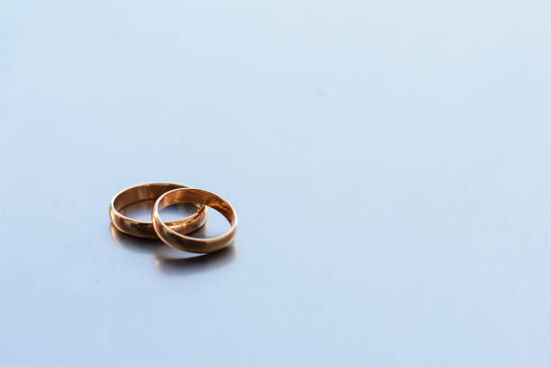 istock two traditional wedding gold engagement rings lie 1225216655