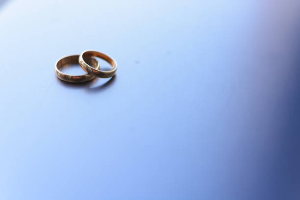 istock two traditional wedding gold engagement rings lie 1225216661